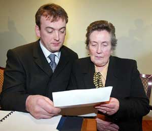 Sean Brown's son Damien and widow Bridie examine the ombudsman's report on Monday