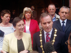 Gearóid Ó hEára, flanked by party colleagues, talks to the media after being elected Mayor of Derry
