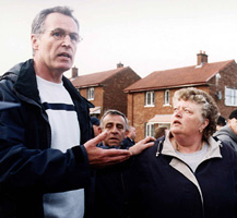 Sinn Féin MLA Gerry Kelly appeals for calm as the PSNI overturned the Parades Commission ruling. He later had an arm broken by a baton as he tried to calm the situation.