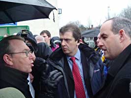 British Minister David Hanson is confronted by Sinn Féin MLA Michael Ferguson over cuts to community funding, while on a visit to the greater Colin area in West Belfast