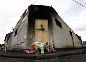 Bray fire — Flowers laid at the site of the factory fire which claimed the lives of two firefighters