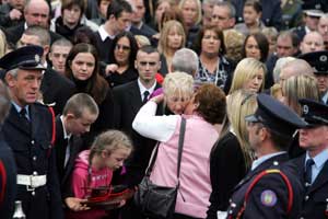 Mary Murray, the wife of Bray fire-fighter Brian Murray, is comforted by a friend at her husband’s funeral