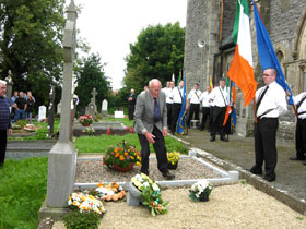 Oliver Brady, a nephew of James Crossan, lays a wreath on the grave