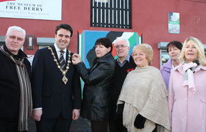 Mayor of Derry, Councillor Gerard Diver is being presented with a Bloody Sunday black ribbon by Mary Nash. Also in photo are family members Leo Young, John Kelly, Kate Nash, Brigid Nash and Linda Nash