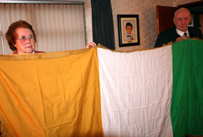THE FLAG: Mary and PJ with the Tricolour that draped the coffin of Volunteer Michael McVerry