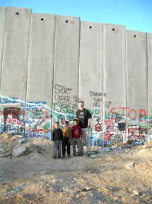 IN PALESTINE: Gerry Adams with Palestinian children at the Separation Wall