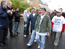 HEADS HELD HIGH: Gerry Adams and Bobby Storey applaud the Visteon workers