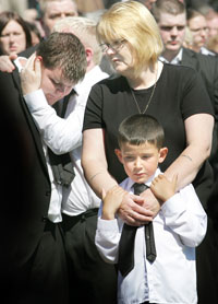 LOSS: Kevin's widow, Evelyn, and son, 'Wee Ryan’, at the graveside