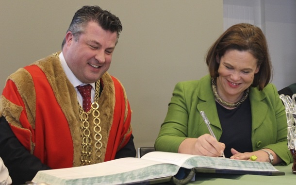 Mary Lou McDonald signs the guest book at the Wexford Opera House alongside Mayor George Lawlor
