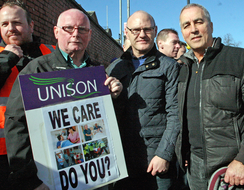 Sinn Féin politicians Paul Maskey MP and Pat Sheehan MLA with striking worker