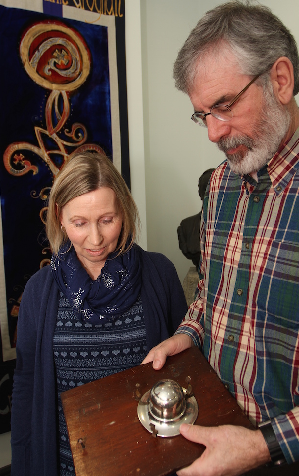 Gerry Adams shows Linda Ervine an ink well used by Padraig Pearse when he stayed in the Cooley Mountains around 1906