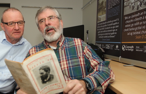 Gerry Adams reading an extract with Jim Gibney from a booklet in praise of Roger Casement