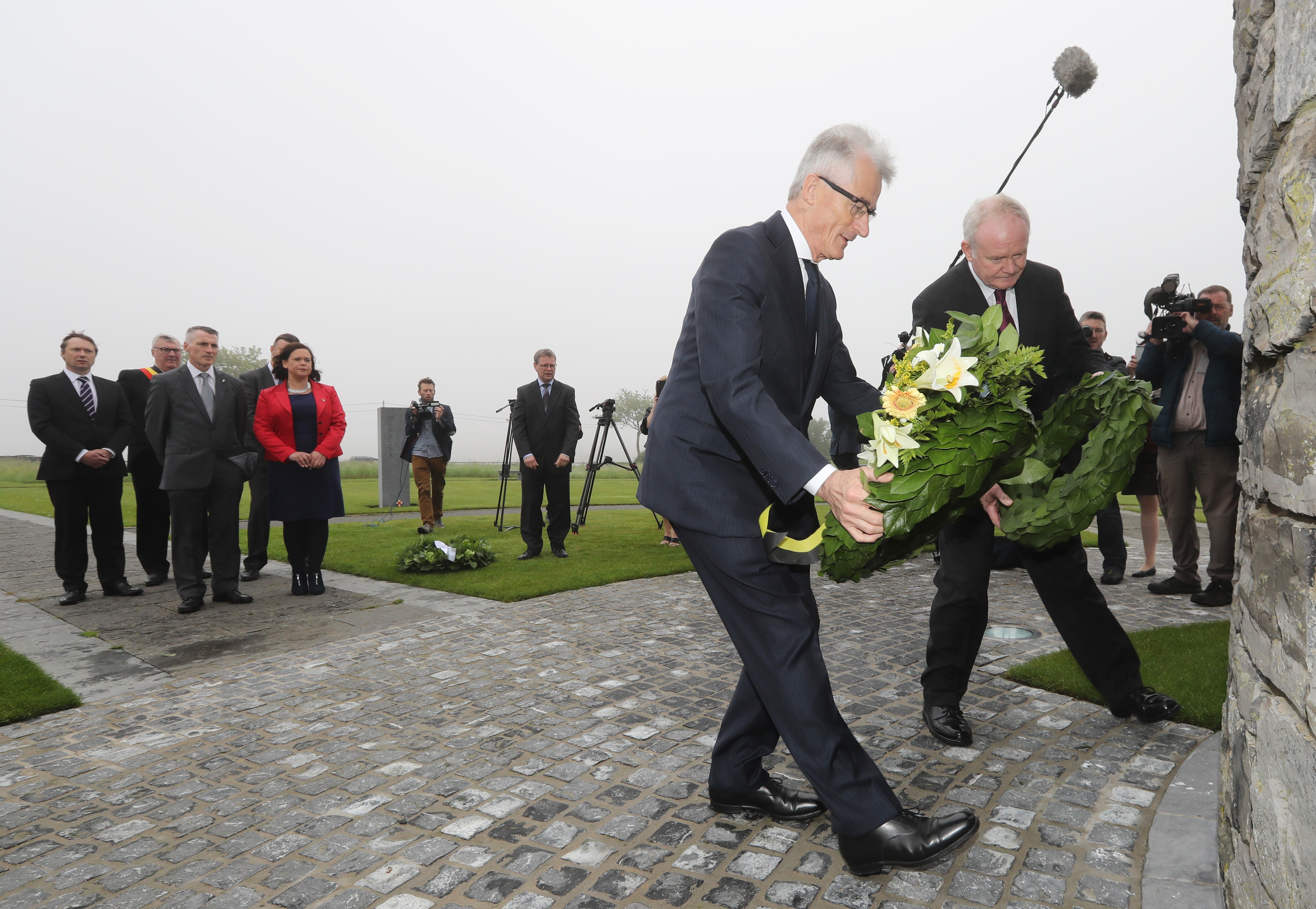 Martin McGuinness laying a wreath to remember those killed in the First World War as Declan Kearney and Mary Lou McDonald look on.