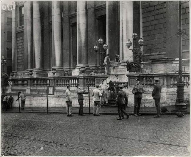 British Army surrounding City Hall with barbed wire barricade after they occupied it on 20 December 1920