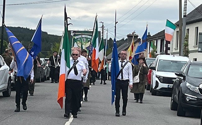 Led by a republican colour party, the parade enters the village of Kiltyclogher