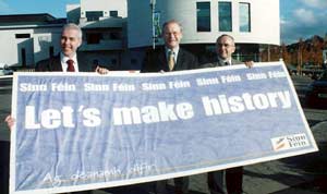 Dermot Kennedy, Martin McGuinness and Paul Butler hold up a Sinn Féin banner