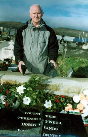 Liam Shannon stands over the desecrated graves