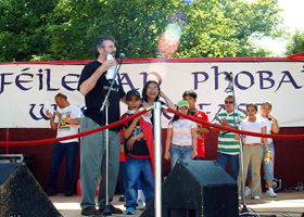 Gerry Adams on stage at the Féile Carnival with members of Belfast's Filipino community