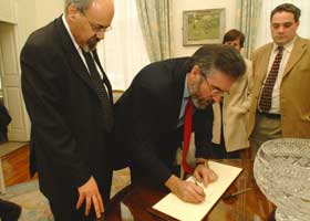 Gerry Adams, accompanied by Palestinian ambassador Ali Halimeh, signs the Book of Condolences for Yasser Arafat in Dublin's Mansion House