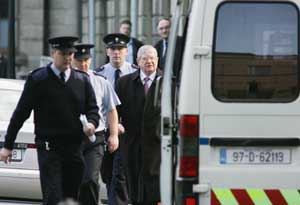 Former Fianna Fáil minister Ray Burke is led off to serve his time