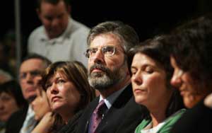 Adams sits with the McCartney sisters before his address