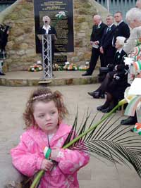 A young republican holds an Easter lily, as Annie Cahill addresses the crowds