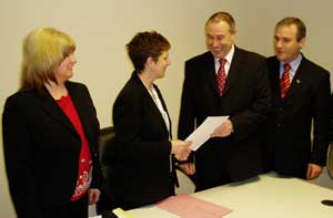 Mitchel McLaughlin (second right) hands in his nomination papers