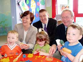 Caitríona Ruane, John O'Dowd and Martin McGuinness with children from the Whiterock Creche