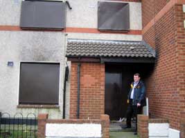 Feilim Mac Críosta outside a boarded up council house in Clondalkin