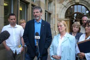 Gerry Adams with families of suicide victims and Belfast community workers after the meeting with the British minister