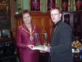 Alan McBride being presented by Sinn Féin mayor of Derry, Lynn Fleming on behalf of council