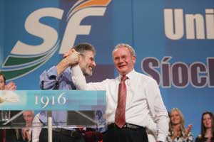Sinn Féin Chief Negotiator Martin McGuinness is congratulated by Gerry Adams