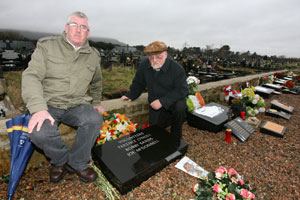 Padraig McCotter of the Belfast National Graves Association and Martin Meehan look at the desecrated graves after the attack on the Republican Plot at Milltown Cemetery