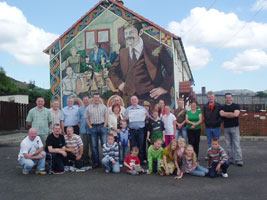 Former prisoner Paddy Fegan is pictured with members of the Ballymurphy Ex-POW group, members of the committee and relatives of Volunteer Tommy ‘Todler’ Tolan at the newly updated mural commemorating the IRA Volunteer. Fegan presented a cheque for £