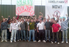 Britcamp – Ógra members erect two banners at the entrance to the former British army base claiming victory at their demilitarisation weekend