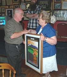 Nóirin Sheridan presenting Peter Daly’s relative and namesake, Peter Daly will special edition framed commemorative poster signed by Bob Doyle