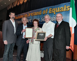 Pádraigín Uí Mhurchadha receives presentation from Martin Ferris TD.  Also in picture are Cllr. Seán Conlon, Pádraigín’s husband Matt Murphy and Caoimhghín Ó Caoláin TD