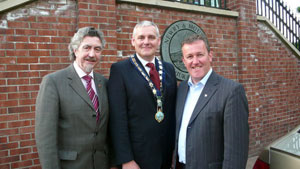 FIRST: New mayor Colman Burns is congratulated by Sinn Féin comrades Mickey Brady MLA and Conor Murphy MP
