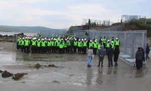 NTIMIDATING: A huge force of security workers employed by Shell confront locals on what is a public beach at Glengad