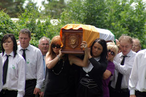 Coffin being carried by members of the Bailey family
