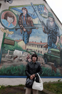 THE BOYS FROM BALLYMURPHY: Patrick Mulvenna's widow Frances at the commemorative mural for Patrick and his comrade Jim Bryson