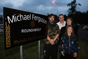 Michael Ferguson's partner Louise, sons Hugh and Daibhibd and daughter Niamh at the newly renamed roundabout in Poleglass