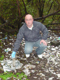 DANGEROUS: Robert Ballesty amidst the drugs debris littering the park where children play