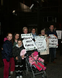 ‘HOMES NOT FORTS’: Local families with Niall Ó Donnghaile (right) call for Mountpottinger’s closure