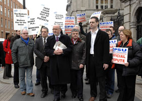 STANDING FIRM: Sinn Féin Oireachtas members stand with the public sector workers