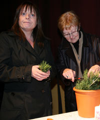 Brenda Downes and Sister Consilio select a sprig of Rosemary at the commemoration event