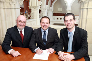 SIGNING UP FOR A FIGHT: Pádraig signs his nomination papers flanked by Caoimhghín Ó Caoláin TD and Senator Pearse Dohery