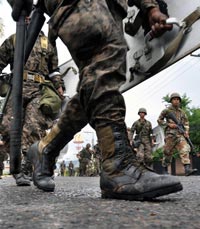 JACK-BOOT: Soldiers patrol a street near the presidential building in Tegucigalpa