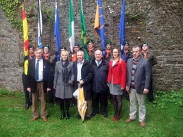 Fra McCann with Cork Sinn Féin councillors and a colour party in Fianna uniforms