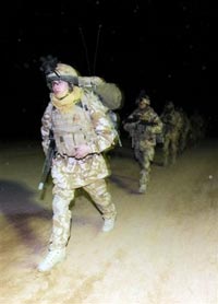 British soldiers make their way onto helicopters as they prepare for Operation Moshtarak